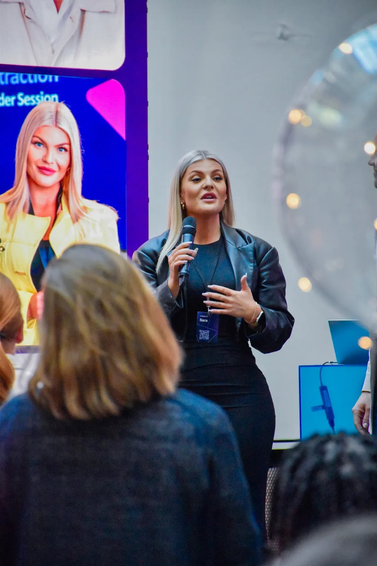 Adway host presenting on stage at the Talent Community Afterwork session