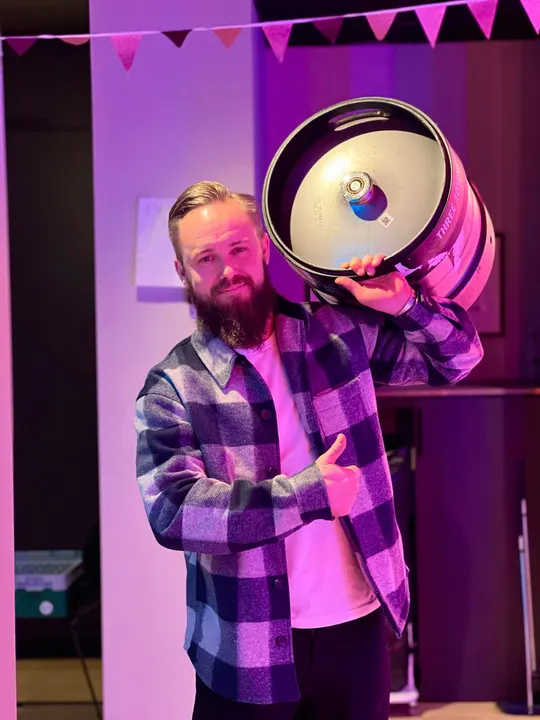 An Adway team member carrying a beer keg on his shoulder