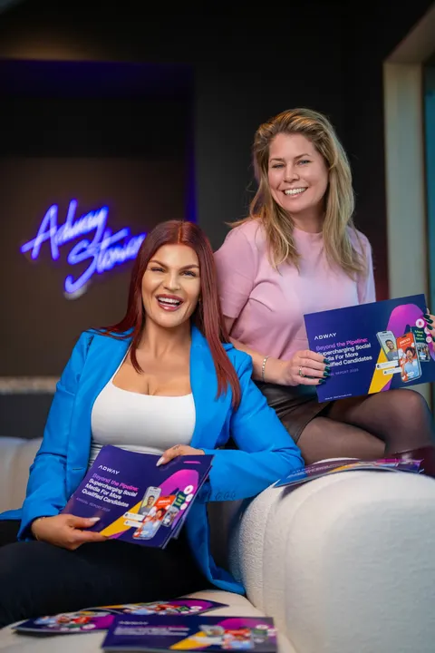 Two Adway team members holding Adway's 2025 annual report