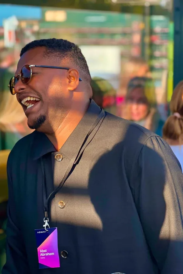 Abel Abraham laughing with colleagues at an Adway event